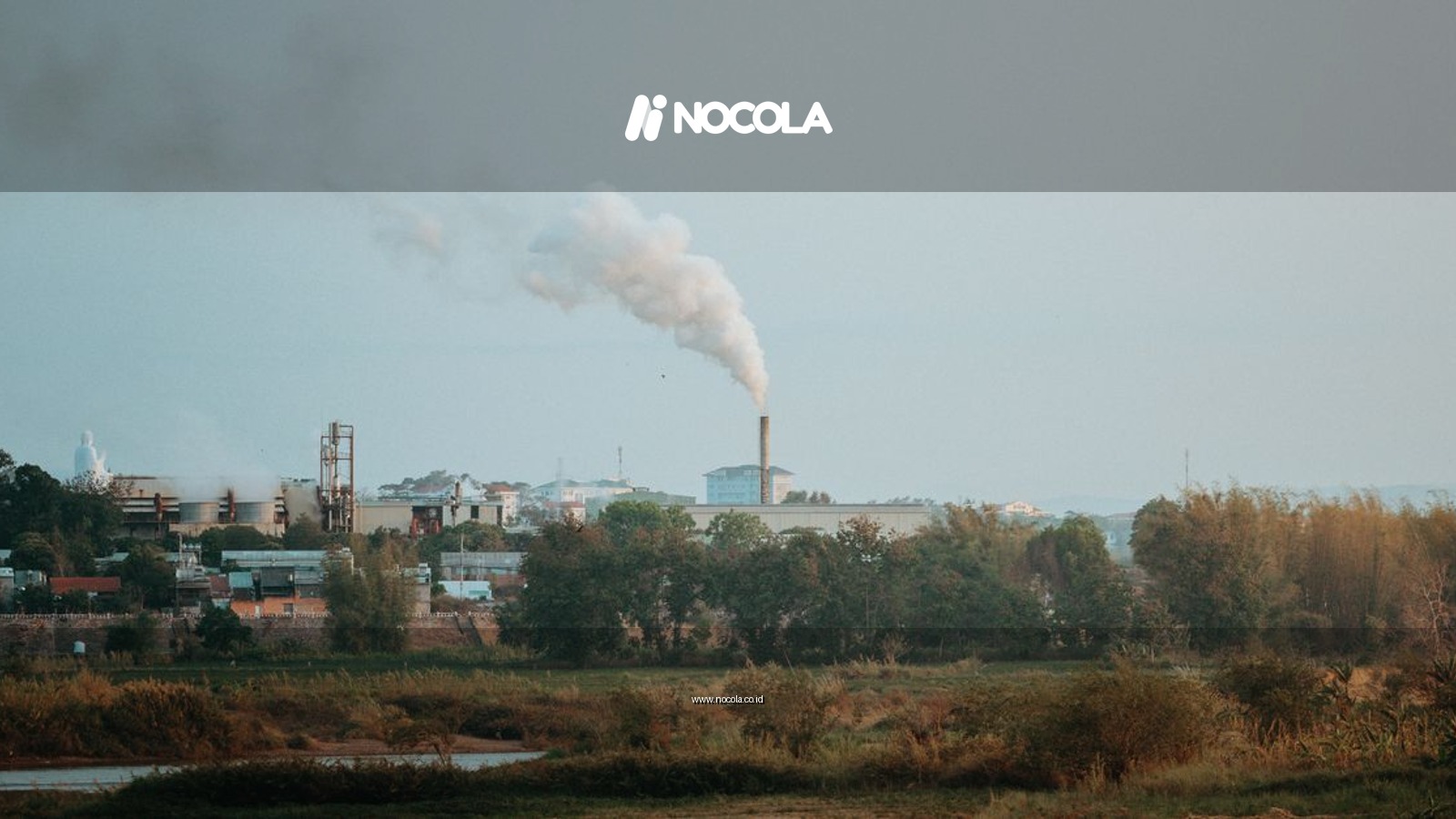 Scenic view of industrial area emitting smoke in Kon Tum, Vietnam amid lush greenery.