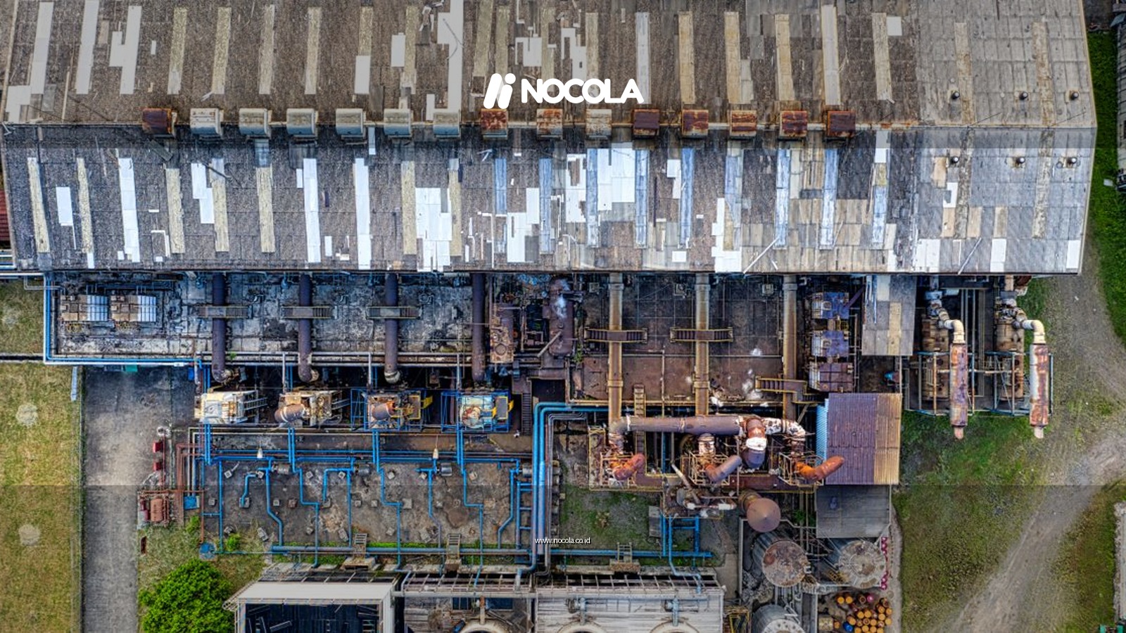Drone view of old industrial buildings and reservoirs of factory with cooling fans