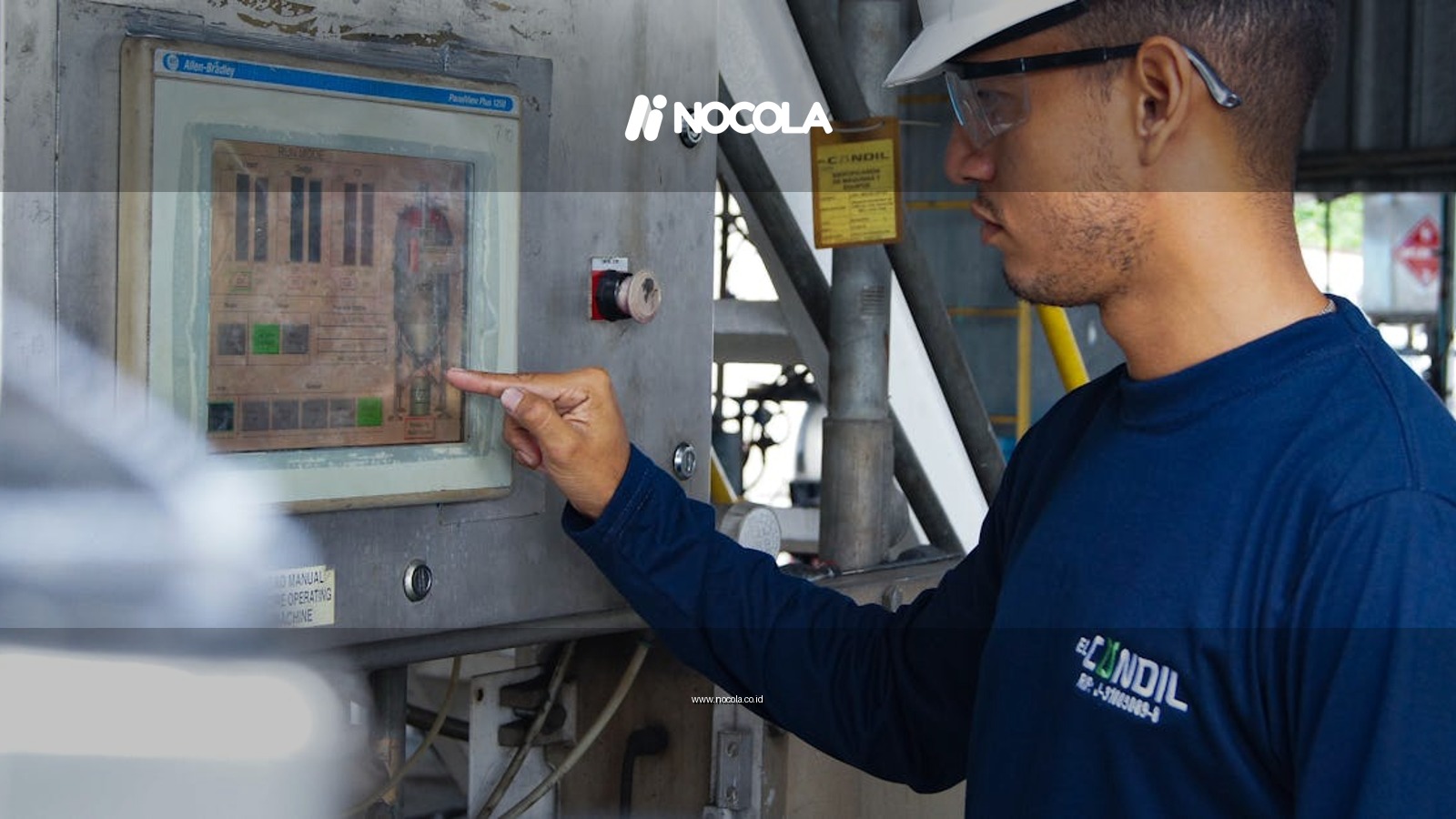 Engineer using control panel at industrial facility, ensuring operational efficiency.