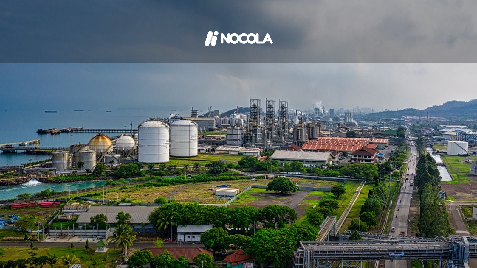 Aerial view of a coastal industrial area in Banten, Indonesia, with factories and overcast skies.