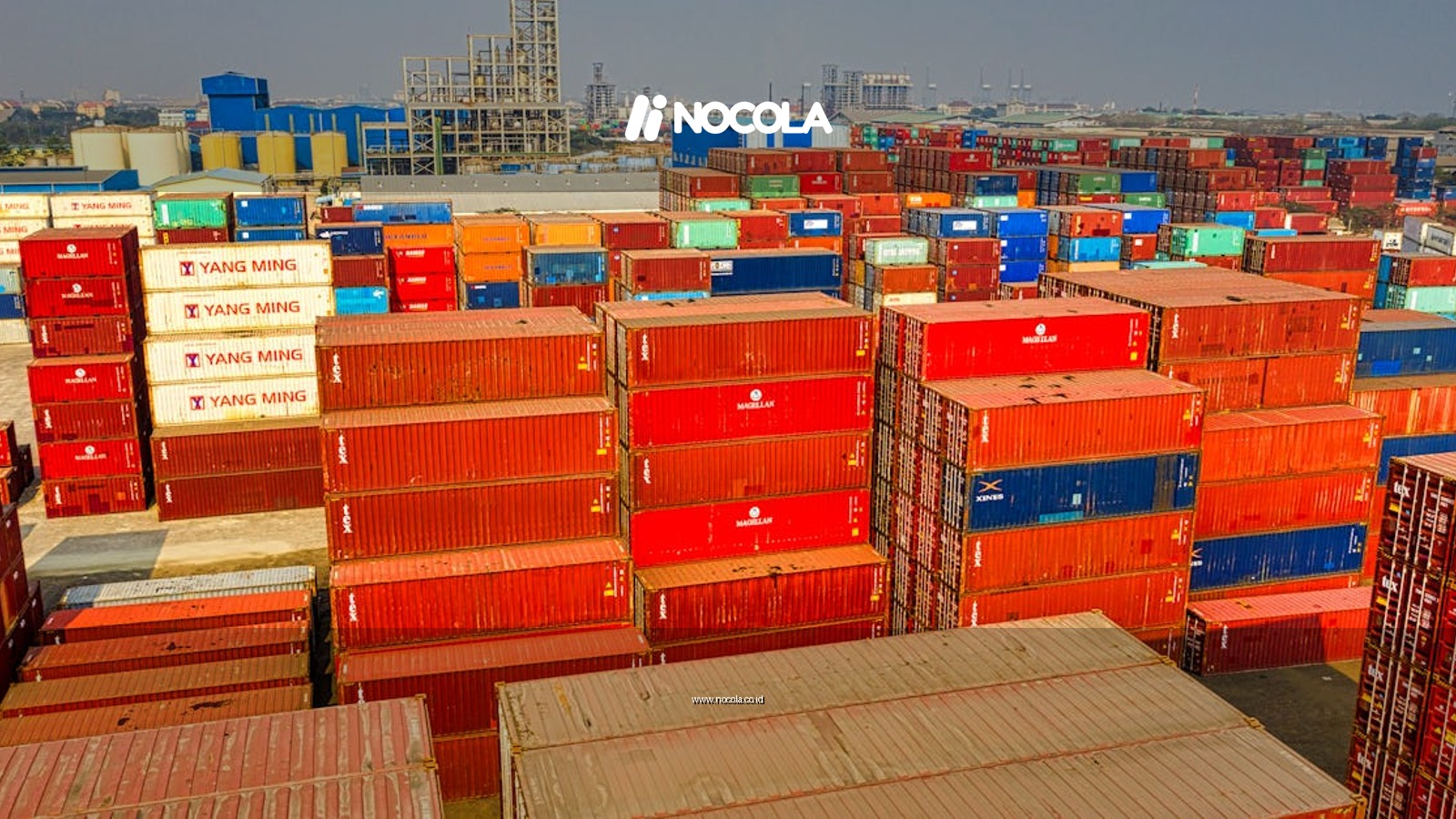 Drone shot showcasing stacked colorful cargo containers at Jakarta port.