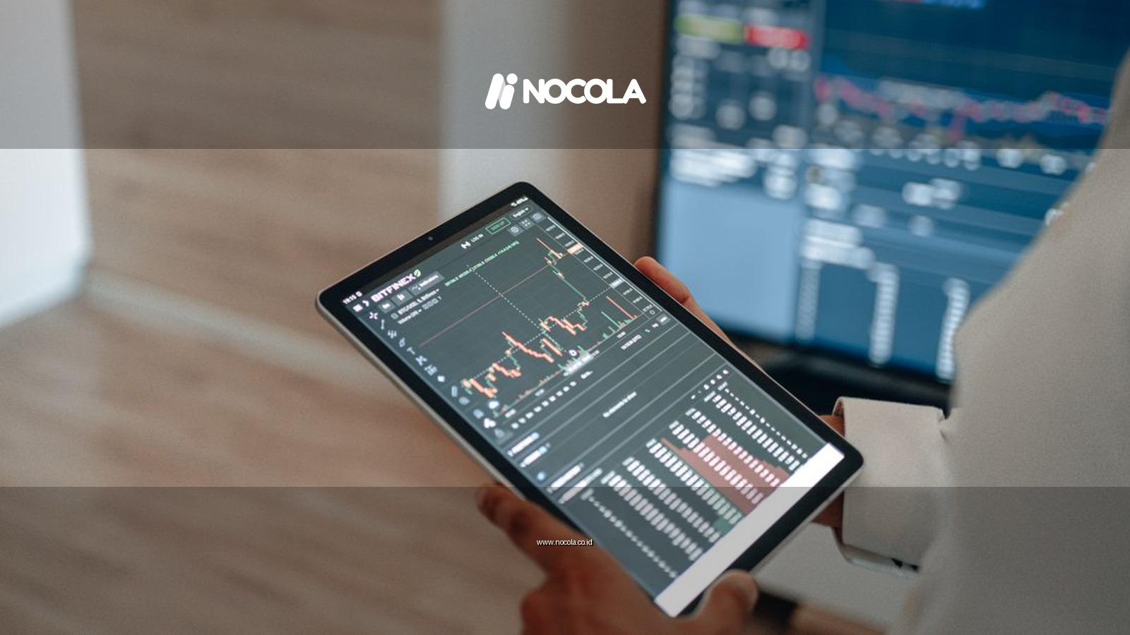 A person uses a tablet to monitor stock market trends and real-time trading graphs.