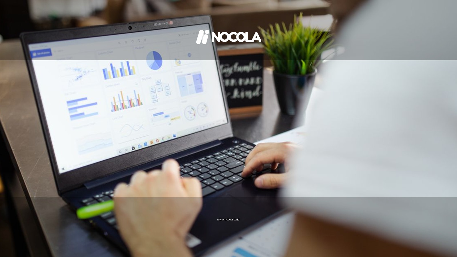 Focused business analysis with charts and graphs on a laptop in a modern office setting.