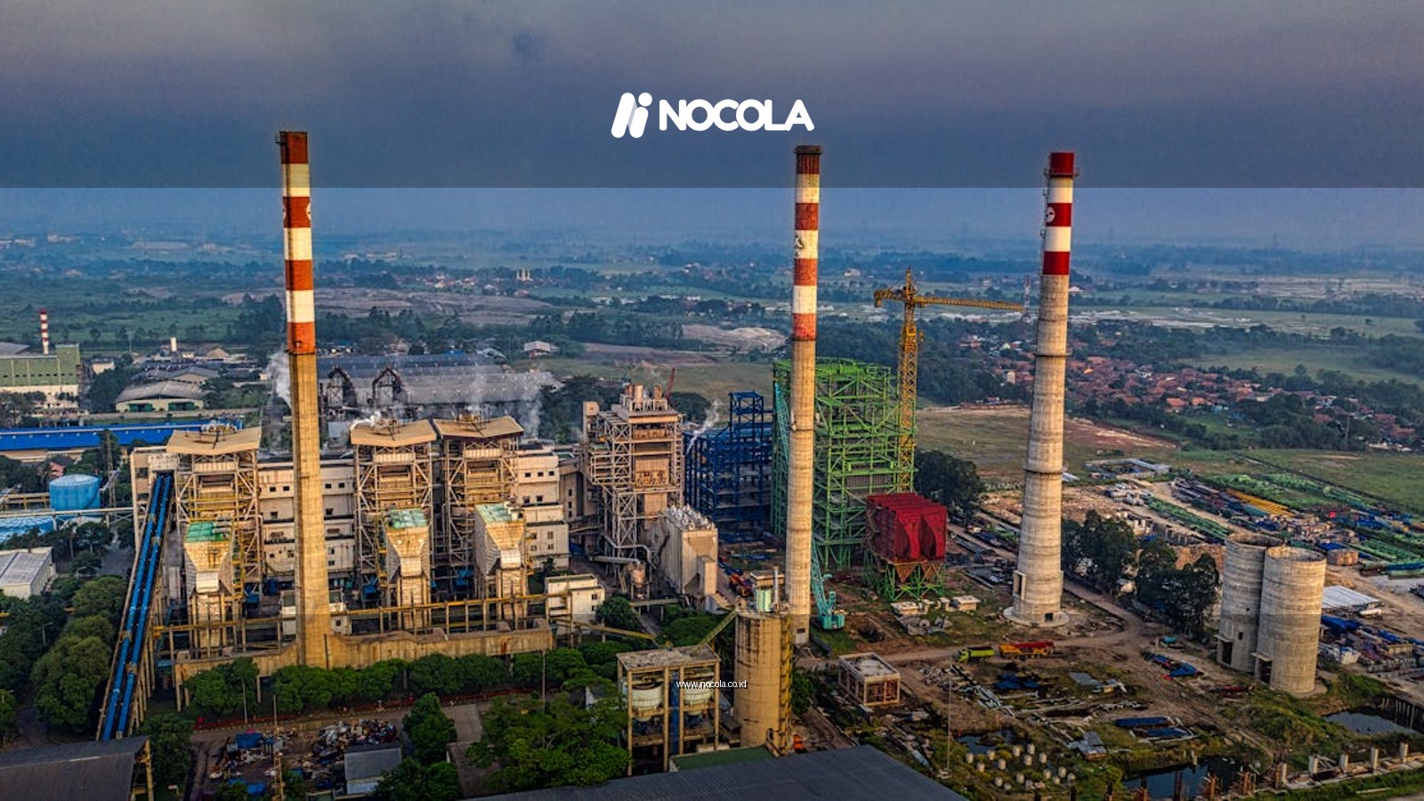 Aerial view of an industrial plant with smokestacks in Serang, Banten, Indonesia during daylight.