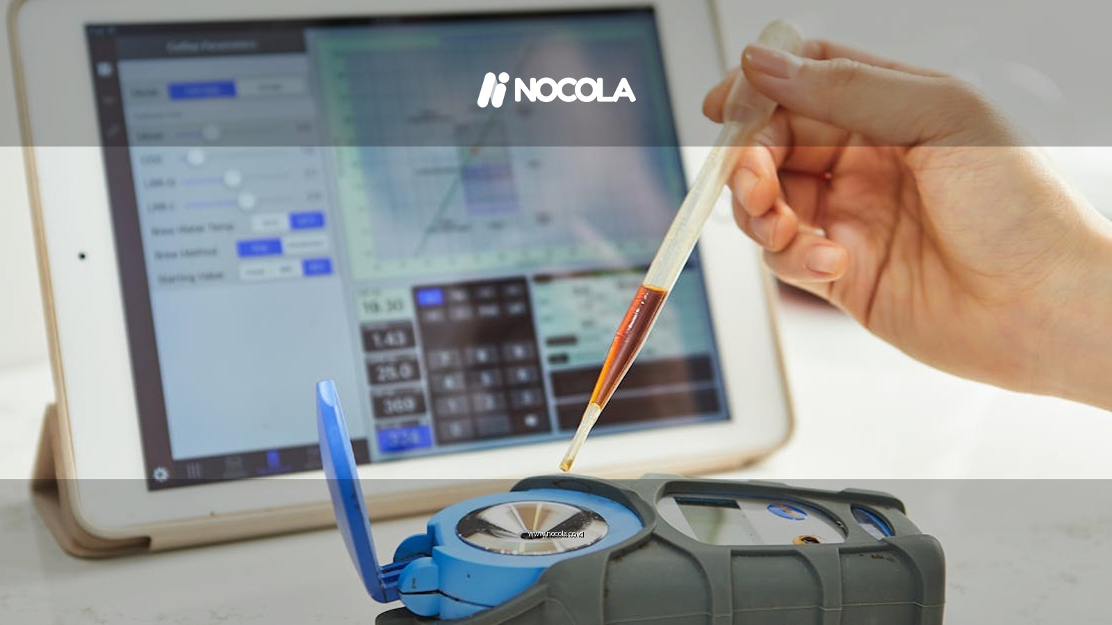 Hand using pipette with refractometer in front of tablet displaying measurement interface.