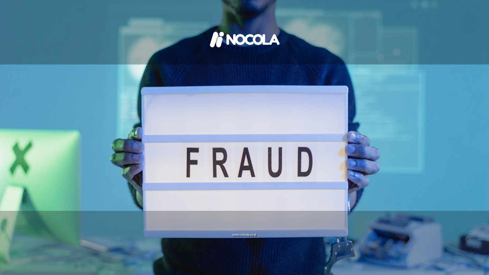 A man holding a sign reading 'FRAUD' in a tech environment, highlighting cybersecurity concerns.