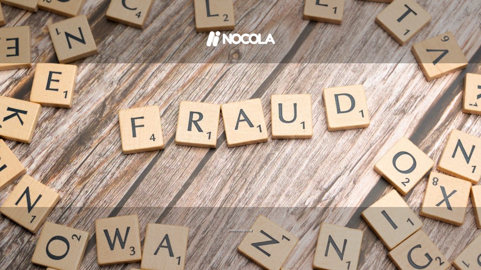 Alphabet tiles arranged to spell 'fraud' on a wooden surface, symbolizing deception.